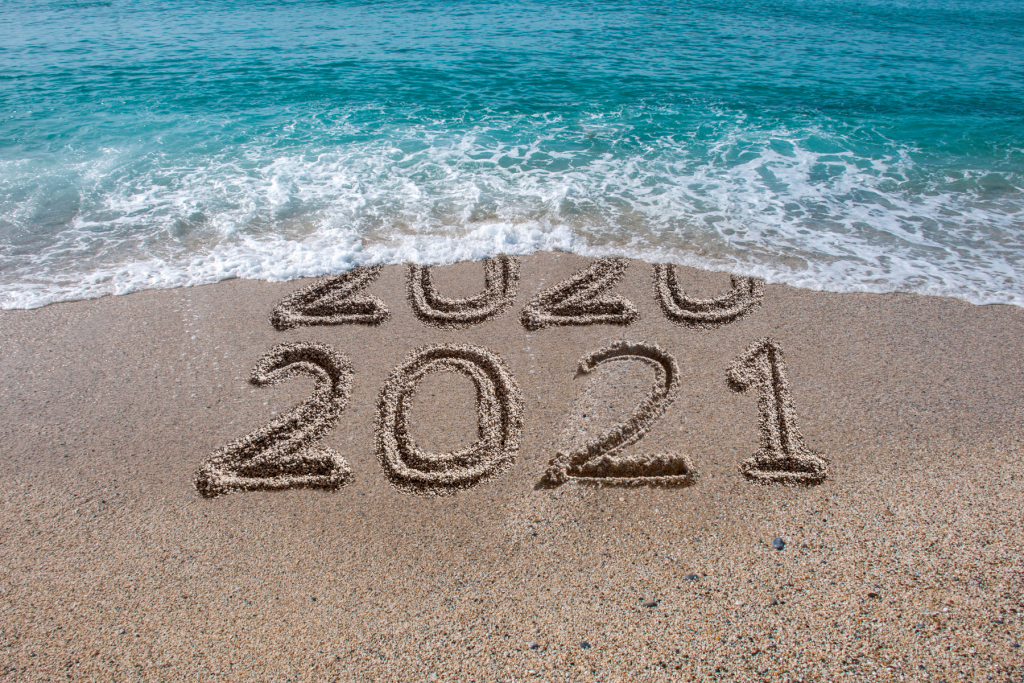 2020 turning into 2021 on a beach