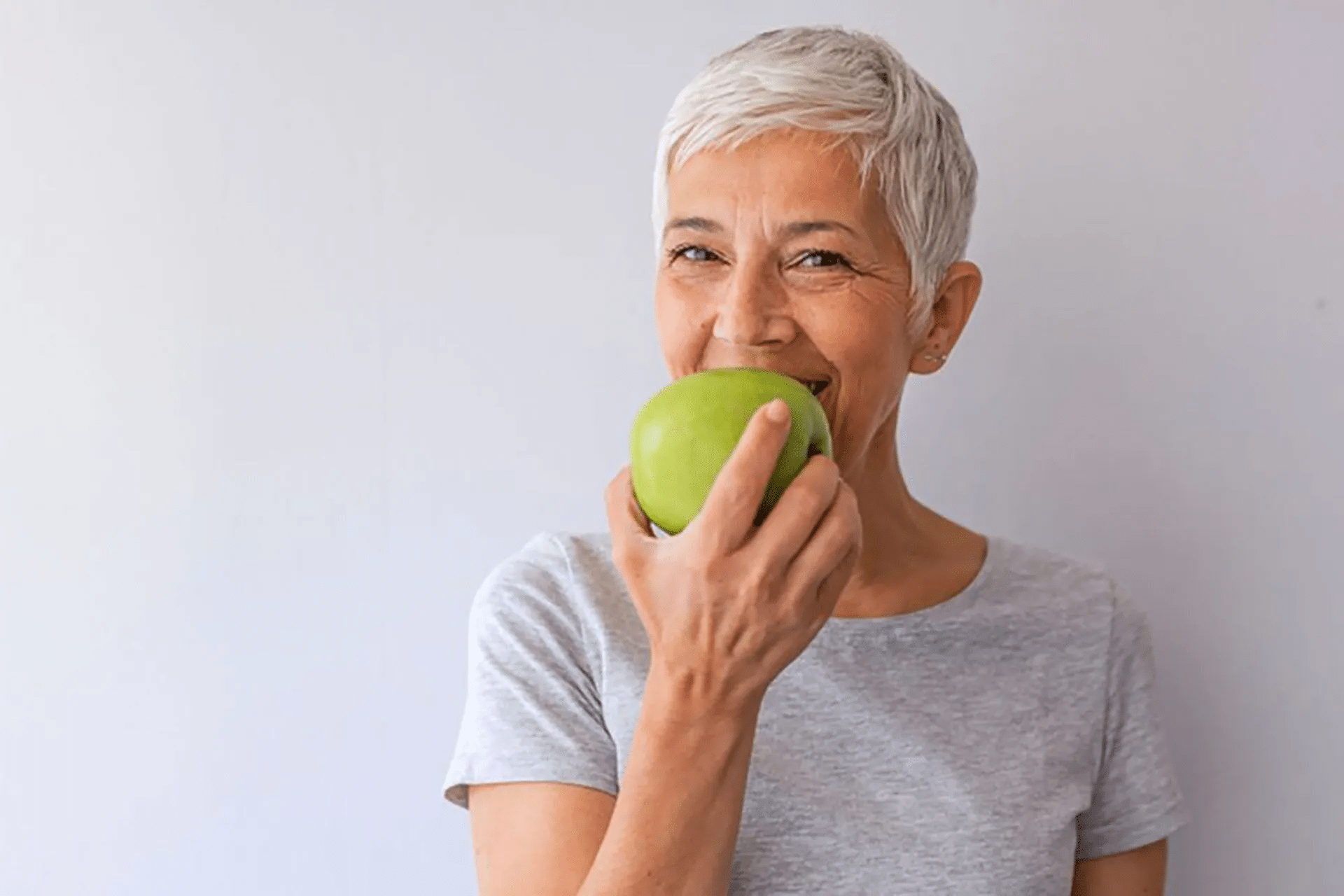 Longevity woman eating an apple 1