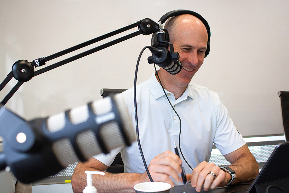 Todd smiling while recording a podcast