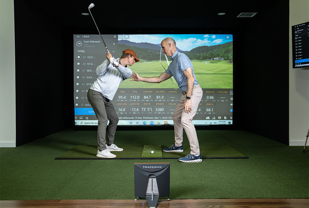 golfer working on his swing on a golf simulator