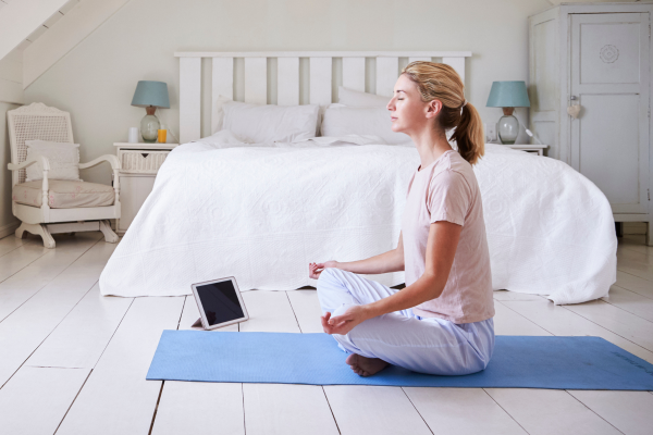woman meditating using an app