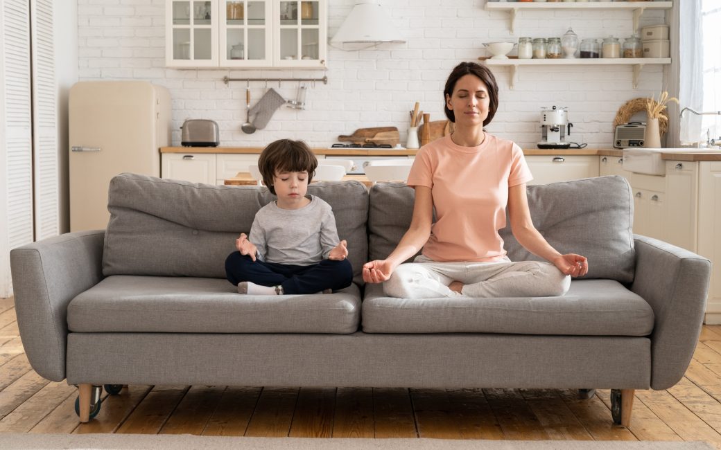 woman meditating with her son