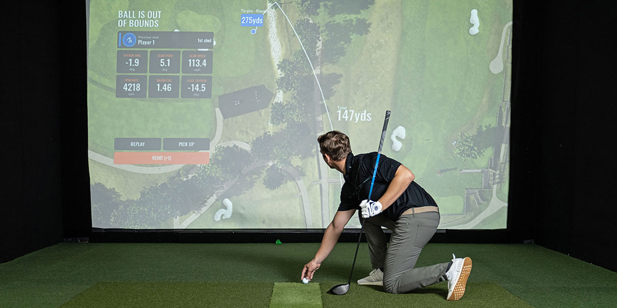 golfer looking at metrics real-time on the trackman