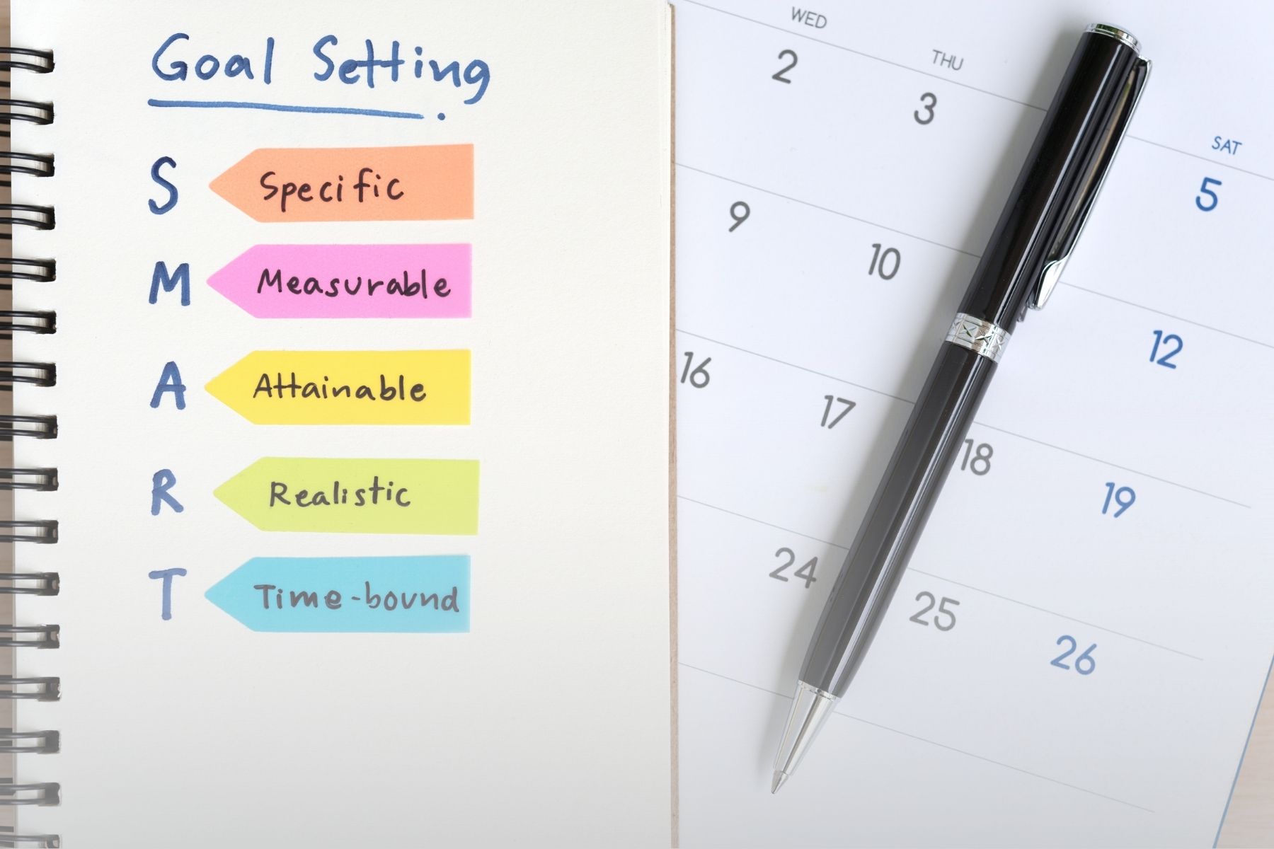 calendar and notebook with smart goals