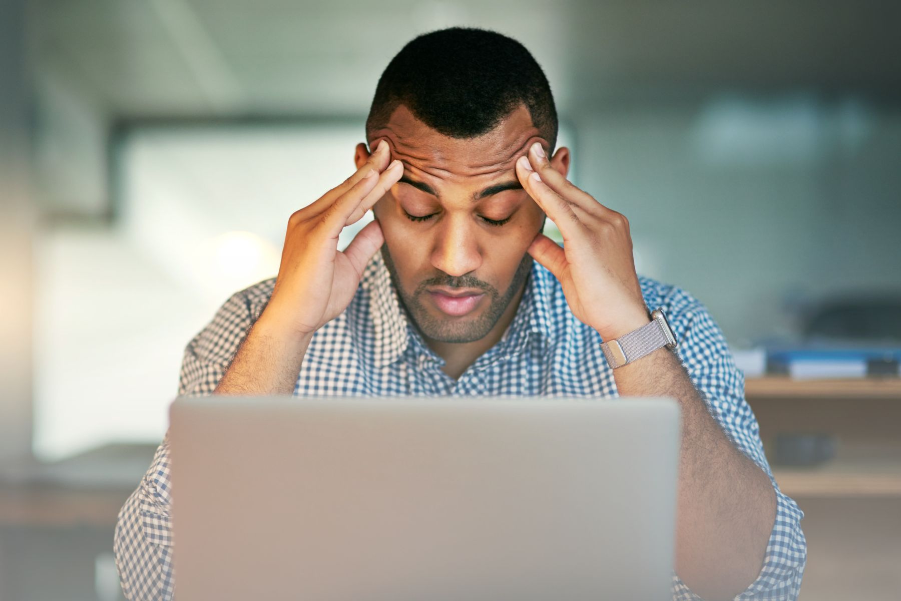 man stressing out over a computer