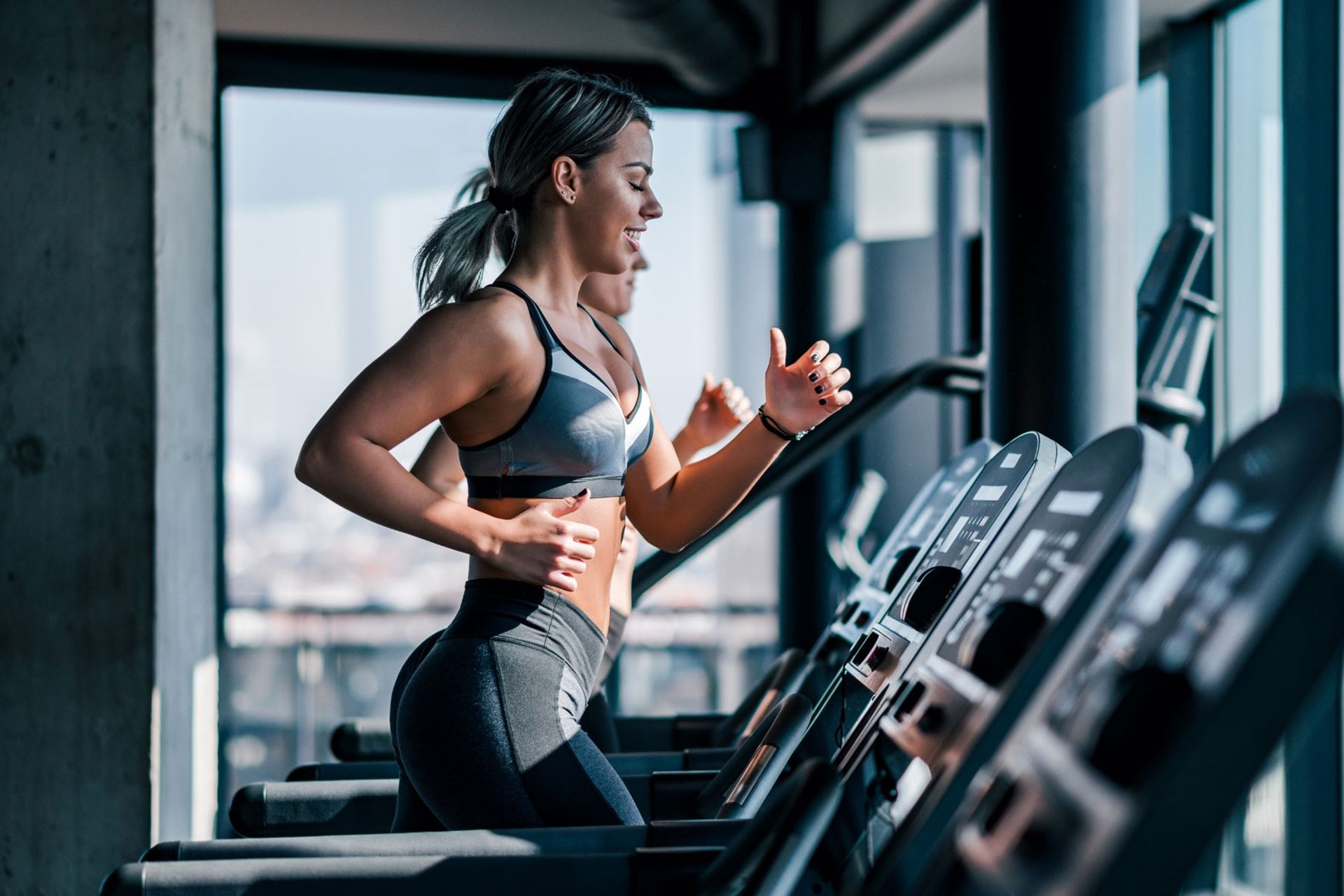 Group of happy smiling muscular sports fitness female and male adults people  standing together as good friends in gym with sport equipment in background  after a difficult workout session Photos